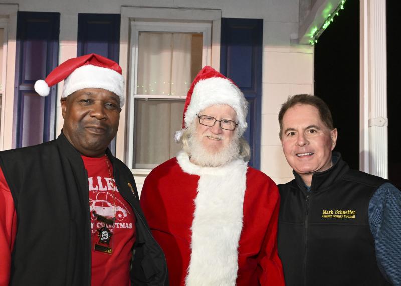 Helping brighten the holiday season are (l-r) Greg Fuller, president of FOP Lodge 2; Santa Claus; and Sussex County District 3 Councilman Mark Schaeffer.